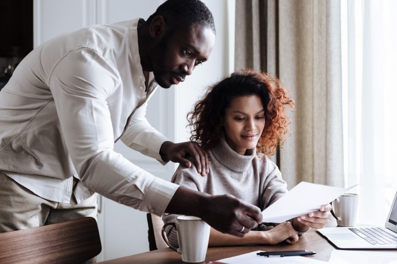 Couple reviewing documents at home - Network vs traditional medical aid plans: what you save and what you give up