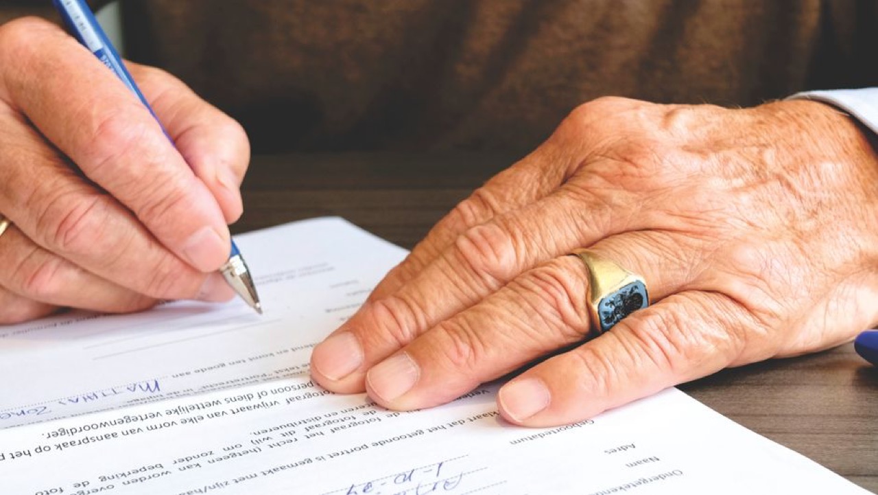 Signing documents desk - Maternity benefits checklist: what to check on your medical aid before you fall pregnant