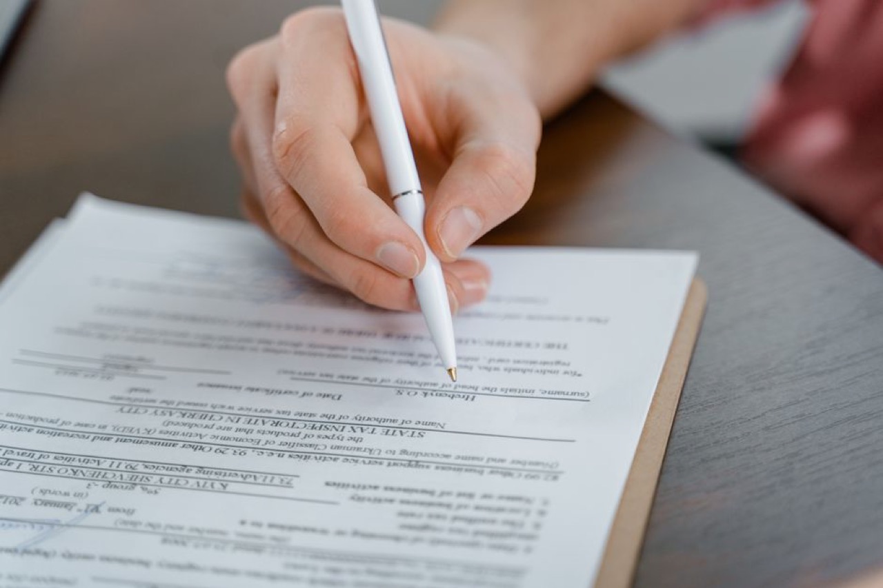 Filling in a form with pen - Questions to ask before joining a medical aid scheme (with what a good answer looks like)